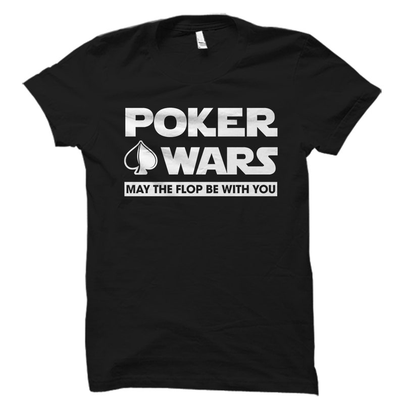 May include: Black t-shirt with white text that reads "Poker Wars" with a spade symbol and the phrase "May the flop be with you".