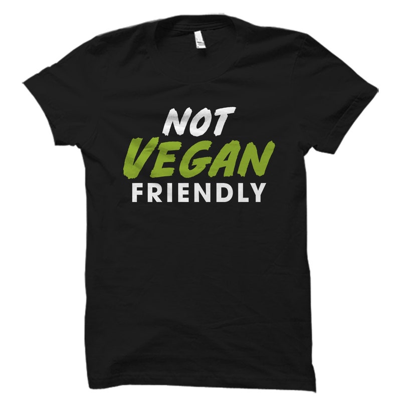 May include: Black t-shirt with white text that reads "Not Vegan Friendly" in a green font.