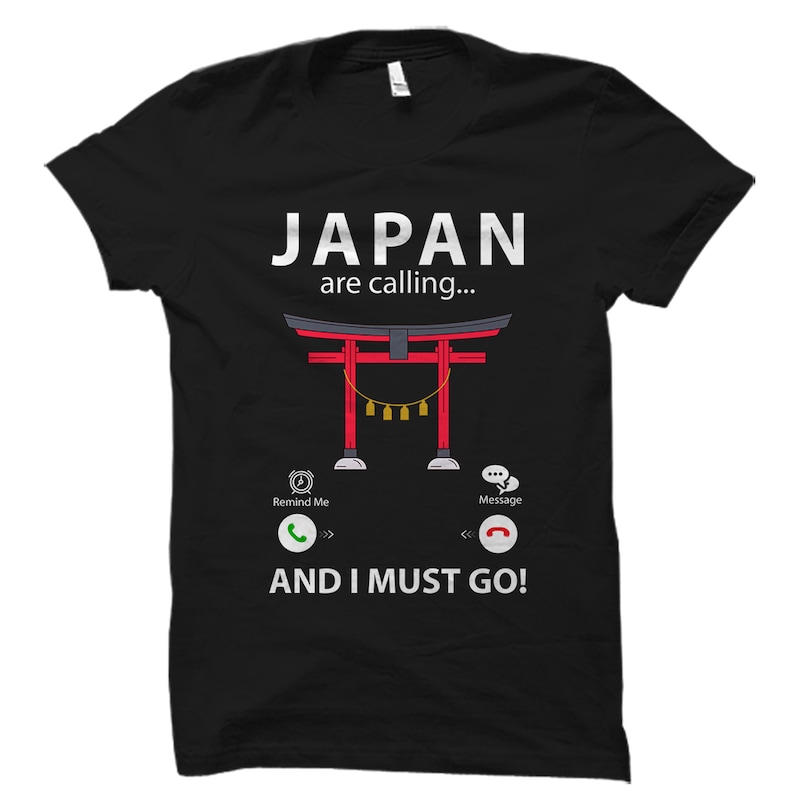 May include: Black t-shirt with a white graphic of a red Japanese torii gate with the text "JAPAN are calling..." and a phone icon with the text "AND I MUST GO!"