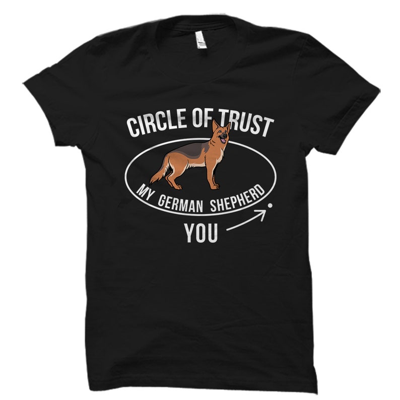 May include: Black t-shirt with white text that reads "Circle of Trust My German Shepherd You" with an arrow pointing to the right. A cartoon German Shepherd is inside a circle above the text.