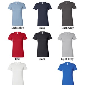 May include: A selection of t-shirt colors, including light blue, navy, dark grey, red, black, light grey, white, and blue.