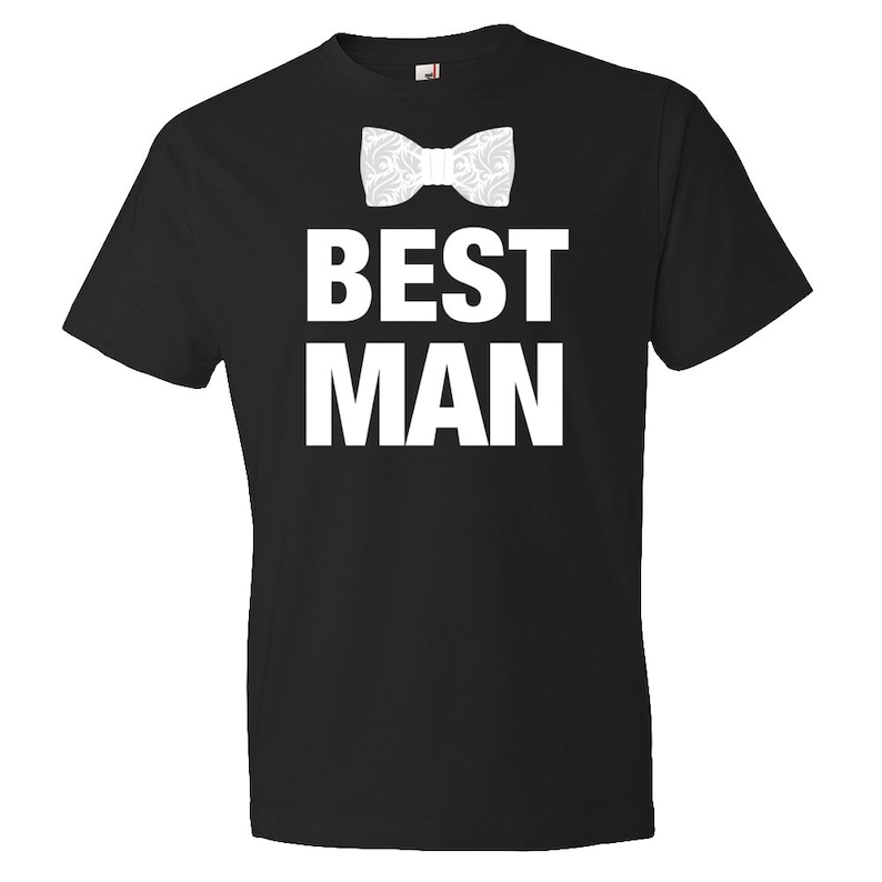 May include: Black t-shirt with white text that says "Best Man" and a white bow tie graphic.