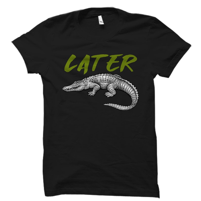 May include: Black t-shirt with a green "LATER" graphic and a black and white illustration of an alligator.