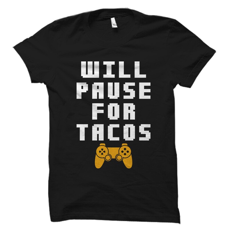May include: Black t-shirt with white text that reads "WILL PAUSE FOR TACOS" and a yellow video game controller graphic.