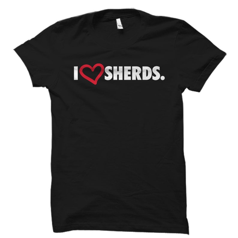 May include: Black t-shirt with a white graphic that says "I love SHERDS."