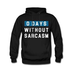 May include: Black hooded sweatshirt with a white graphic that says "0 DAYS WITHOUT SARCASM" in a blue box.