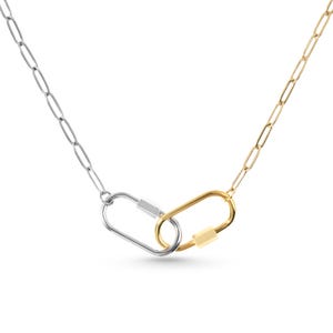 May include: A silver chain necklace with a gold and silver carabiner clasp.