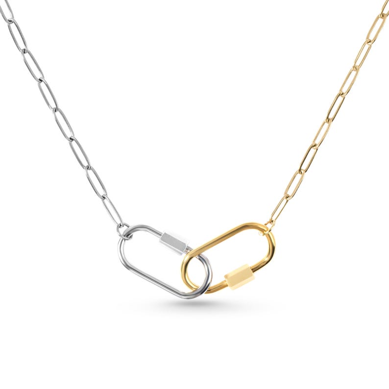 May include: A silver chain necklace with a gold and silver carabiner clasp.