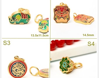 May include: Four gold charms with enamel detailing. The charms are shaped like an elephant, a lion dance mask, a dragon, and a lotus flower. The charms are approximately 13.5 x 11.5 cm, 14.5 cm, 13.5 cm, and 10 x 9.5 cm in size.