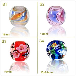 May include: Four glass beads with different designs. The first bead is white with gold and blue swirls. The second bead is pink with purple swirls. The third bead is red with pink flowers. The fourth bead is blue with fish and seaweed. The beads are 16 mm in diameter, except for the fourth bead, which is 15 x 20 mm.