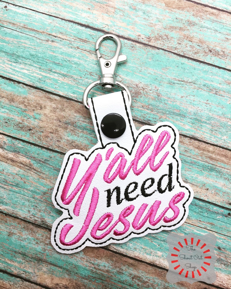 May include: Pink and black embroidered keychain with the text "Y'all need Jesus".