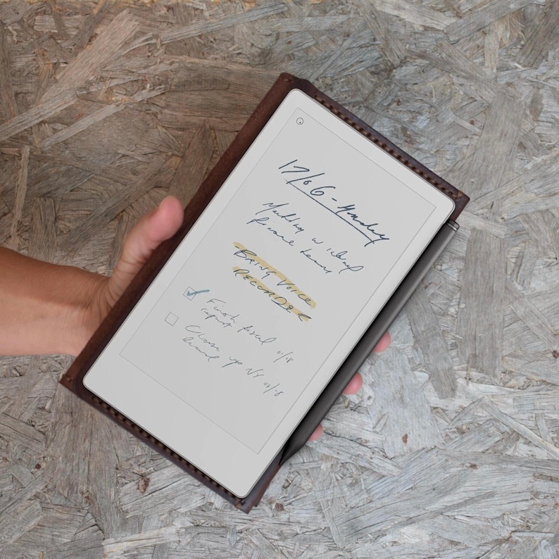 May include: A brown leather tablet case with a digital notepad displaying handwritten notes. The notes include the date, "17/6/6-Monday", and the words "BRING Voice RECORD". A black stylus is attached to the side of the tablet.