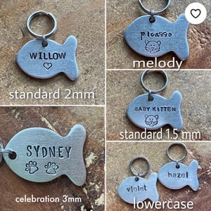 May include: Four silver fish-shaped pet ID tags with different names and designs. The tags are available in three sizes: standard 2mm, standard 1.5mm, and celebration 3mm. The tags feature a paw print, a heart, and a cat silhouette.