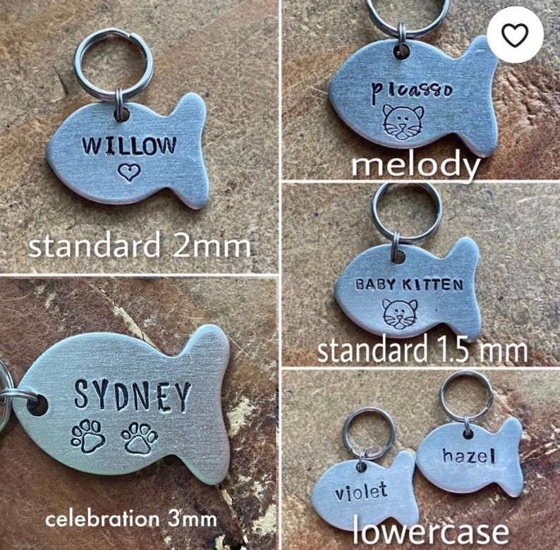 May include: Four silver fish-shaped pet ID tags with different names and designs. The tags are available in three sizes: standard 2mm, standard 1.5mm, and celebration 3mm. The tags feature a paw print, a heart, and a cat silhouette.