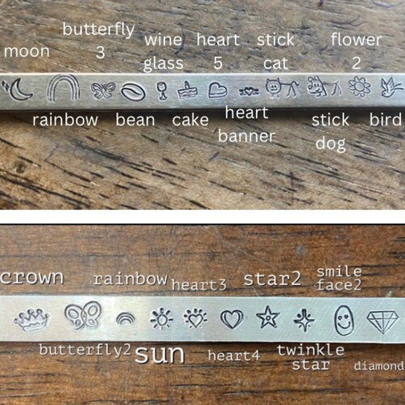 May include: Close-up of two metal stamp sets with various symbols and words. The top set includes symbols for a moon, rainbow, butterfly, coffee bean, wine glass, cake, heart, cat, stick, flower, and bird. The bottom set includes symbols for a crown, butterfly, rainbow, sun, heart, star, and diamond. The words on the sets include "moon", "butterfly", "wine", "heart", "stick", "flower", "rainbow", "bean", "cake", "heart", "banner", "stick", "bird", "dog", "crown", "rainbow", "heart", "star", "smile", "face", "butterfly", "sun", "heart", "twinkle", "star", and "diamond".