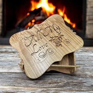 May include: A wooden box with a hinged lid. The lid is open and features a carved design with the words "All My Love" and a stylized rose. The box is made of light wood with a natural finish.
