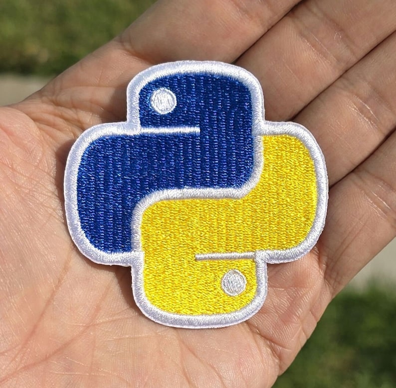 May include: A blue and yellow embroidered iron-on patch shaped like the Python programming language logo.
