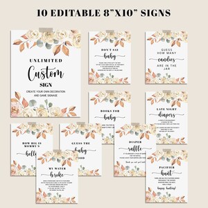 May include: Ten editable 8" x 10" signs for a baby shower. Each sign has a floral design with text such as "Don't Say Baby", "Guess How Many Candies", and "Pacifier Hunt". The signs are attached with tape.
