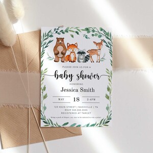 May include: A baby shower invitation with a watercolor illustration of woodland animals, including a bear, fox, raccoon, and deer. The invitation is decorated with green leaves and has the text "Please join us for a baby shower honoring Jessica Smith" and details for the event.
