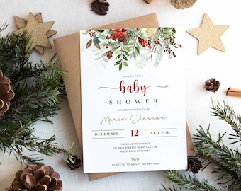 May include: A baby shower invitation with a festive design. The invitation features the words "baby shower" in red script, with floral and berry accents. The invitation is surrounded by pine branches, gold stars, and pine cones.