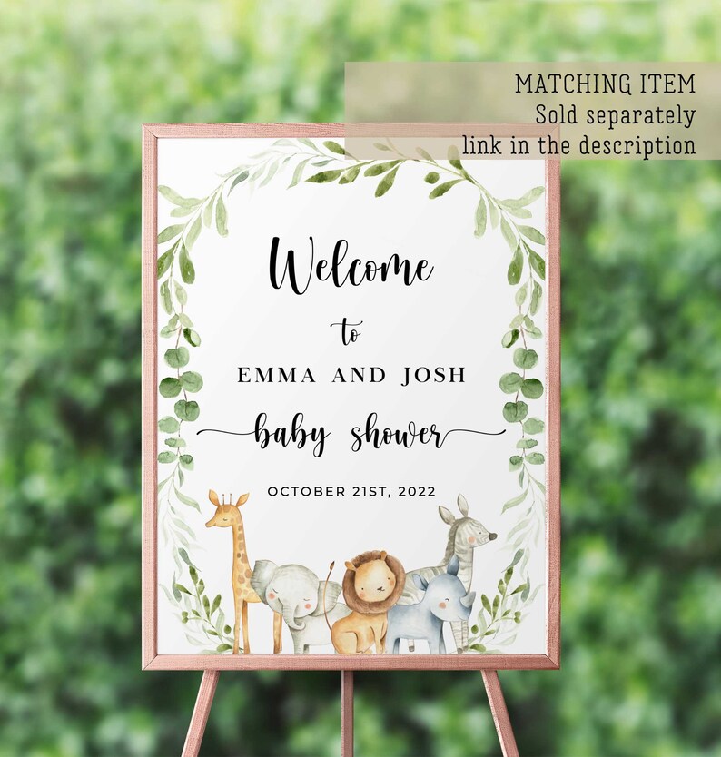 May include: Welcome to Emma and Josh's baby shower sign with a leafy green border and a watercolor illustration of a giraffe, elephant, lion, zebra, and rhinoceros. The sign says "Welcome to Emma and Josh baby shower October 21st, 2022".
