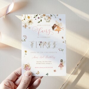 May include: A white invitation card with a floral border and a fairy illustration. The text reads "Our little fairy is turning three. Join us to celebrate Ann's 3rd Birthday. Saturday, July 17th at 3pm. 123 Main Street, Chicago, IL. RSVP to Emma at 555.555.5555."