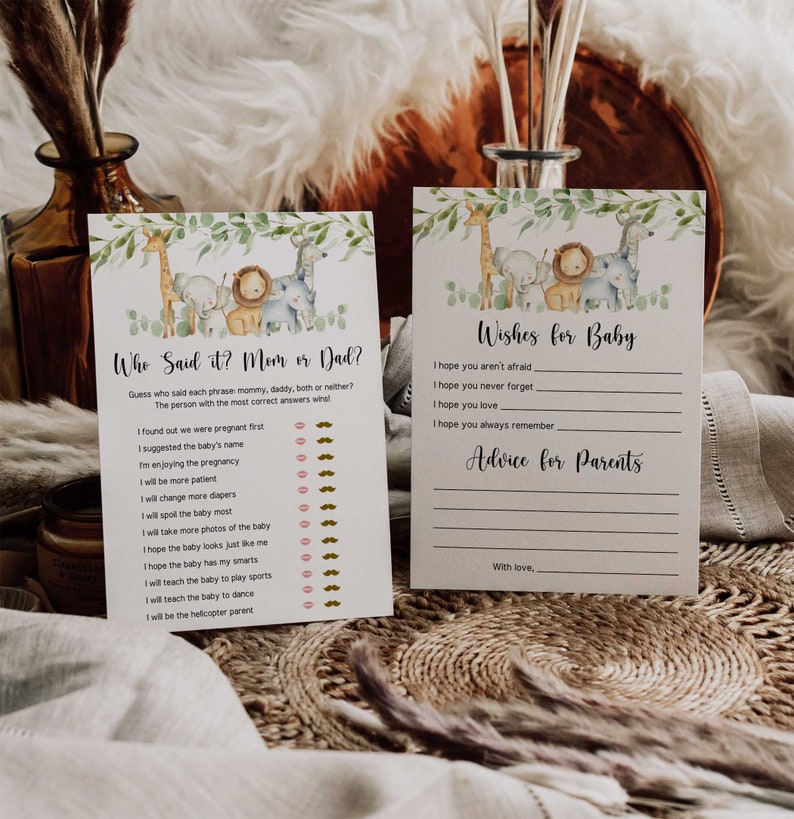 May include: Two printable cards for a baby shower. The first card is a game called "Who Said It? Mom or Dad?" with a list of phrases and spaces for guests to guess who said each phrase. The second card is for guests to write wishes for the baby and advice for the parents. Both cards feature a jungle animal theme with illustrations of a giraffe, lion, elephant, and monkey.
