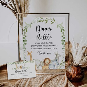 May include: A sign with a watercolor background featuring a giraffe, lion, elephant, and zebra. The sign reads "Diaper Raffle" and "If you bought a pack of diaper for the diaper raffle please leave your tickets here. Thank you."