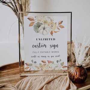 May include: A gold-framed sign with a watercolour floral design featuring pumpkins, leaves, and flowers. The sign reads "UNLIMITED custom sign FULLY EDITABLE WORDS create as many as you need!"