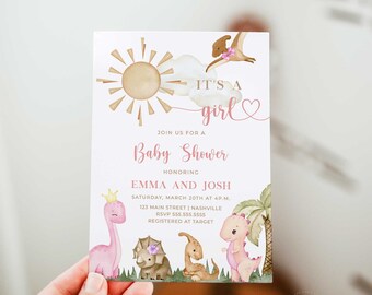 May include: A pink and brown baby shower invitation with a sun, clouds, and dinosaurs. The text reads "It's a girl" and "Join us for a Baby Shower honoring Emma and Josh".