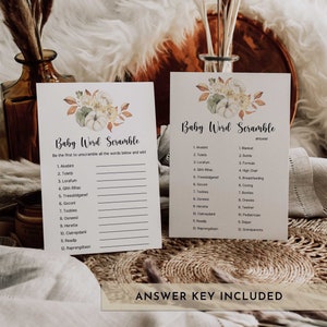 May include: Two baby shower game cards with a floral design featuring pumpkins and leaves. The cards are labeled "Baby Word Scramble" and include a list of scrambled words and an answer key. The phrase "Answer Key Included" is at the bottom.