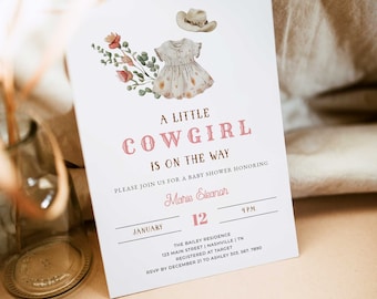 May include: A baby shower invitation with a watercolor illustration of a cowboy hat, dress, and floral elements. The text reads "A Little Cowgirl Is On The Way" in pink and brown lettering. Details include the date, time, and location.