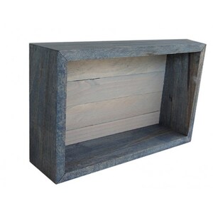 May include: A rectangular, open-front wooden shelf with a gray-blue exterior and a light gray interior. The shelf is constructed from planks of wood, with visible grain. The design is simple and modern, suitable for displaying items.