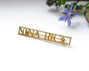 Brooch from Nina Ricci with the brand name