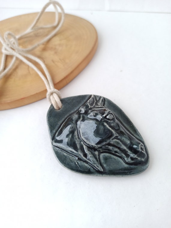 Interesting handmade ceramic pendant with horse he