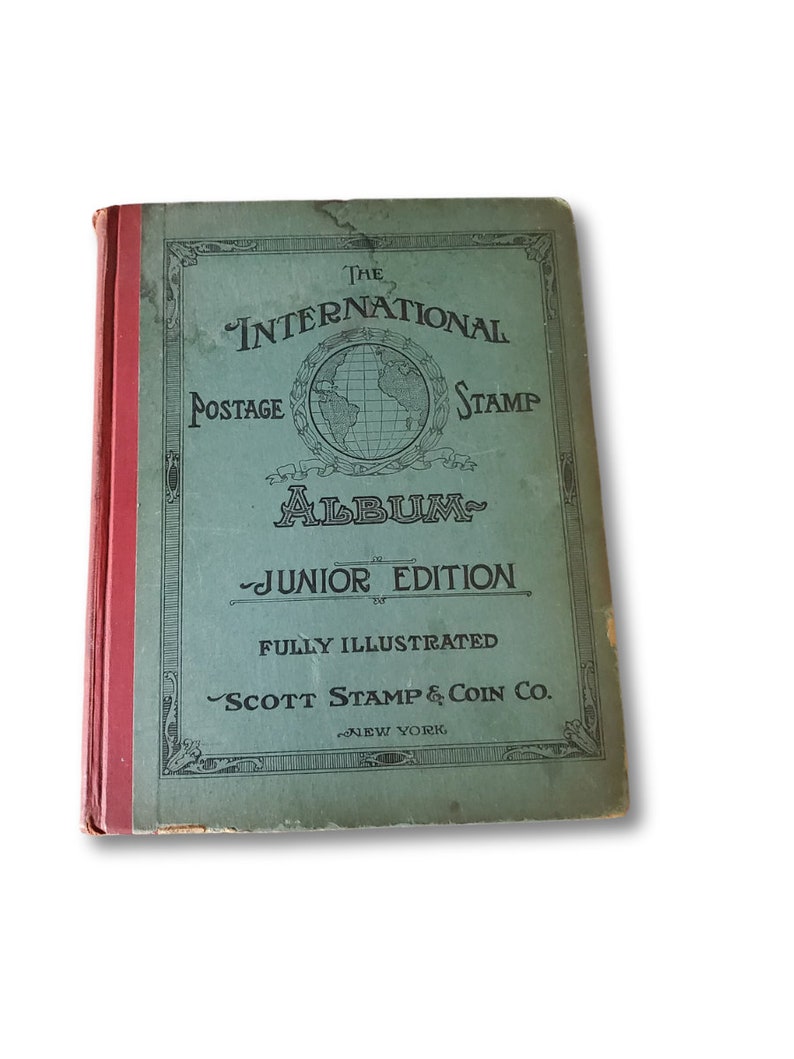 The cover of a green and red book titled "The International Postage Stamp Album - Junior Edition" by Scott Stamp & Coin Co. New York. The book is fully illustrated.