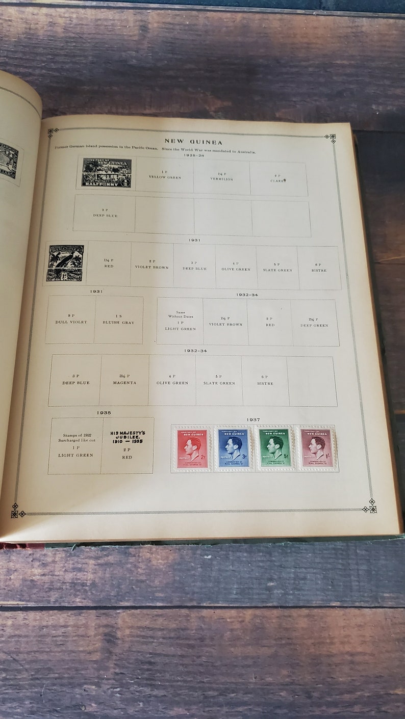 A page from a stamp collecting book showing stamps from New Guinea from 1928 to 1937. The stamps feature various colors and designs, including a portrait of King George V.