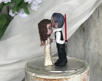 Custom Bride holding Harry Potter Wand and Groom holding Lightsaber Wedding Cake Topper