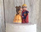 Belle Kissing Blonde Superman Both with Nerd Glasses Wedding Cake Topper
