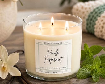 May include: A three-wick soy wax candle in a clear glass jar with a white label reading Vanilla Peppermint, Seedgeeks Candle Co., 100% Soy Wax Candle, and 17 oz. The candle is surrounded by a vanilla flower, vanilla beans, and mint leaves.