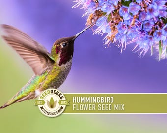 May include: A hummingbird with iridescent green, yellow, and red feathers hovers near purple flowers. The bird's wings are spread, and its long beak is extended towards the blossoms. The image includes the text "Hummingbird Flower Seed Mix" and a logo.