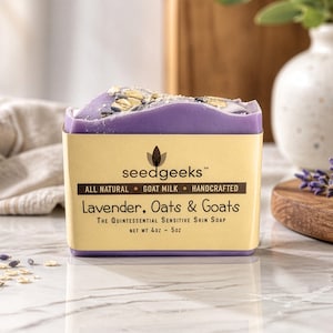 May include: A rectangular bar of lavender-colored soap with oats on top, labeled "Lavender, Oats & Goats." The soap is in a yellow box with the brand name "seedgeeks" and the words "All Natural, Goat Milk, Handcrafted." The net weight is 4 oz.