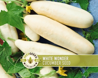 May include: An overhead shot showcases several pale, elongated cucumbers, accompanied by vibrant green leaves and small yellow flowers. The image features the text "WHITE WONDER CUCUMBER SEED" and a logo.