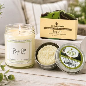 May include: A lit 8 oz soy wax candle labeled Bug Off, a bar of green and brown soap labeled Bug Off, and a round tin containing a cream-colored lotion bar with a bee design, labeled Bug Off Natural Insect Repellant with a barcode.