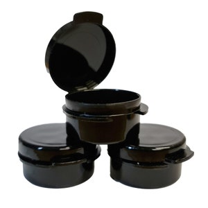 May include: Three black plastic containers with lids. The lids have a lip for easy opening. The containers are stacked on top of each other.