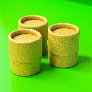 May include: Three brown cardboard tubes with a textured surface. The tubes are stacked on top of each other.