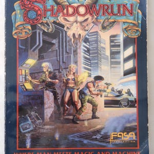 May include: A vintage Shadowrun game box with a futuristic cityscape backdrop. The cover art features three figures with weapons, a skull, and the text "WHERE MAN MEETS MAGIC AND MACHINE."