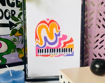 May include: A framed print of a colorful abstract piano. The piano is pink, orange, yellow, and purple with a white keyboard.