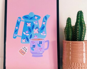 May include: A framed print with a pink background featuring a blue teapot and a purple teacup with floral designs. The text "Put the kettle on" is on a tea bag hanging from the teacup.