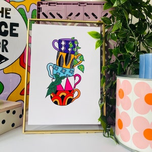 May include: A colourful illustration of a stack of four mugs with different patterns. The mugs are stacked on top of each other and have a leafy green plant growing out of the top mug.